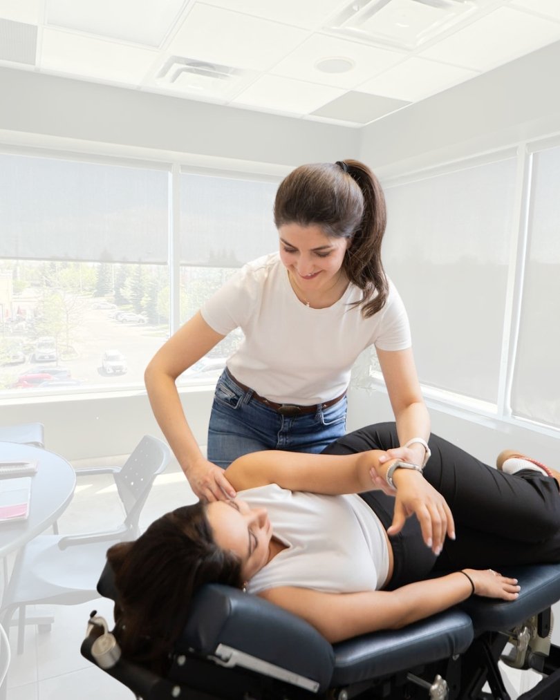 Dr. Pegah guiding a patient through a gentle shoulder and upper-back adjustment at Vieno Wellness